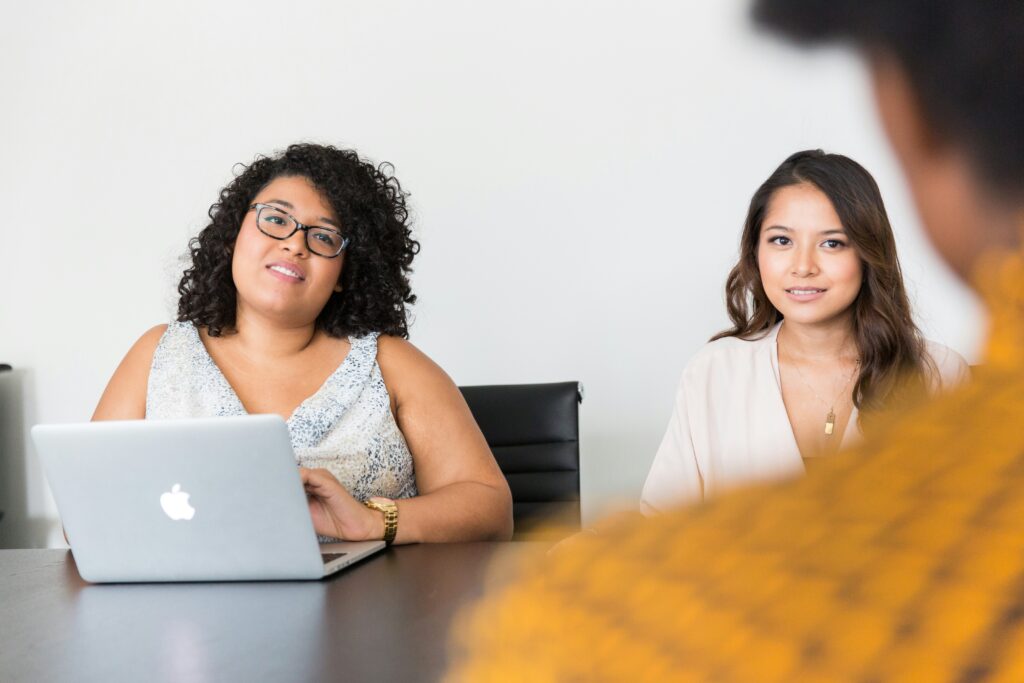 Employees of a small queer-owned business having a meeting discussing developing their marketing plan