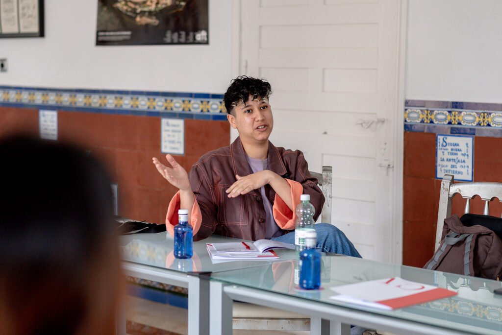 Marketing by Rocio founder and personal branding expert for LGBTQ+ professionals Rocio Sanchez in a meeting talking about how to celebrate Pride Month and LGBTQ+ inclusion in the workplace