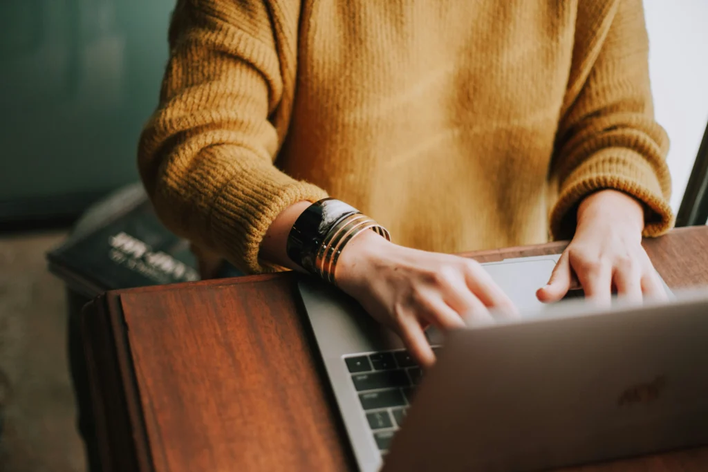 Business owner typing on a laptop, trying to conduct an SEO audit themselves