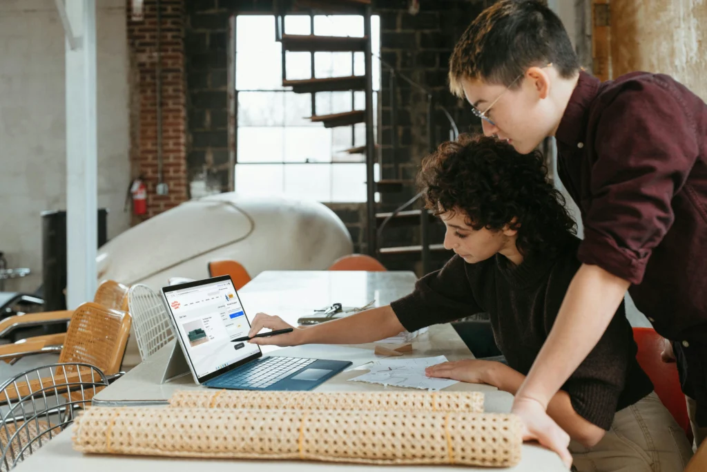 Young professionals looking at their website and strategizing their SEO plan while looking onto a laptop screen.