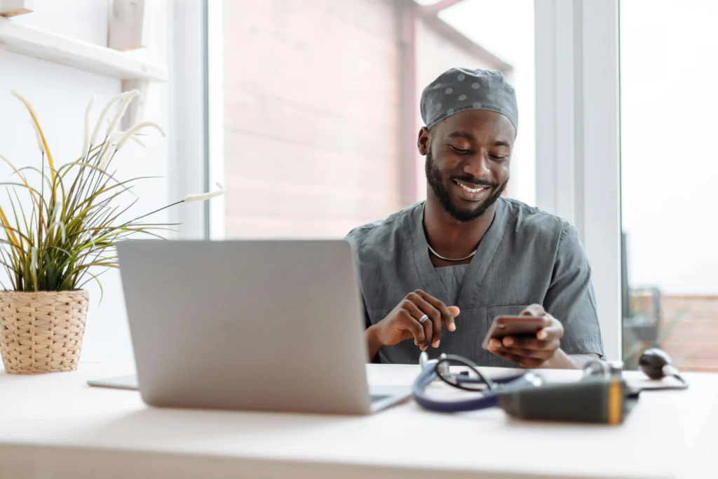 A professional of color checking their website through a mobile phone.