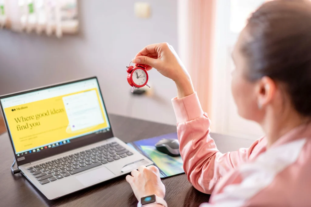 Business owner checking website’s speed while holding a clock.