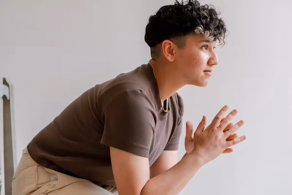 Rocio Sanchez, ADHD business coach and digital strategist, sitting in a focused pose and reflecting on building a business rooted in neurodivergent strengths and self-trust.