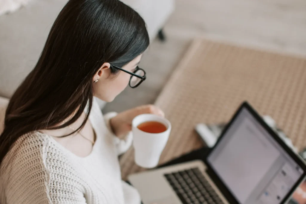 Small business owner reviewing her Weebly website SEO on a laptop while working from home.