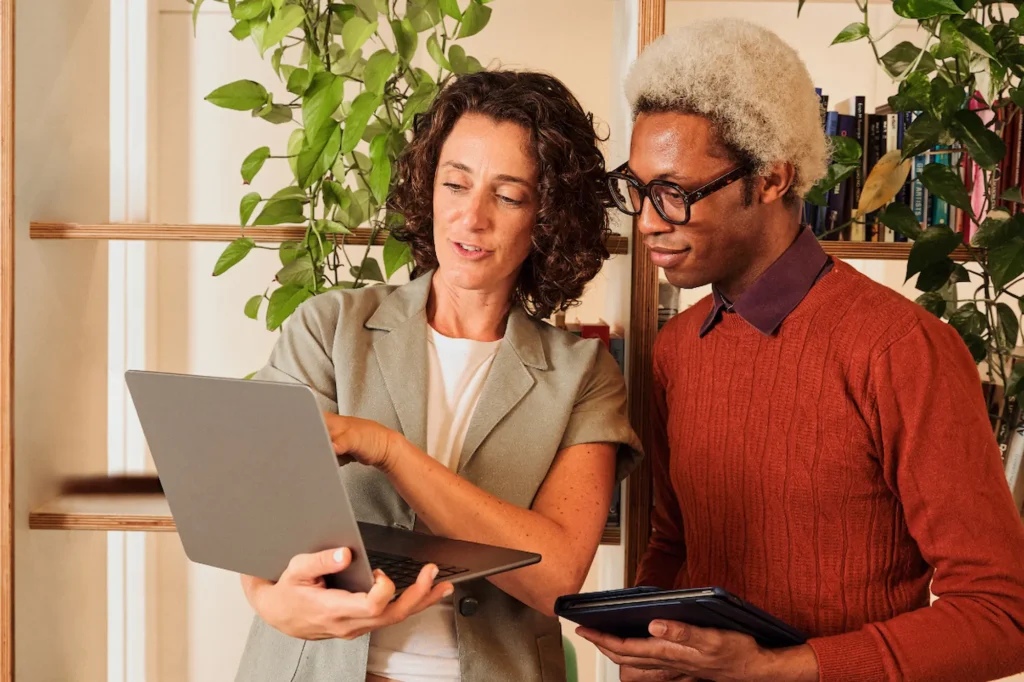 SEO consultant reviewing website strategy with a small business owner on a laptop
