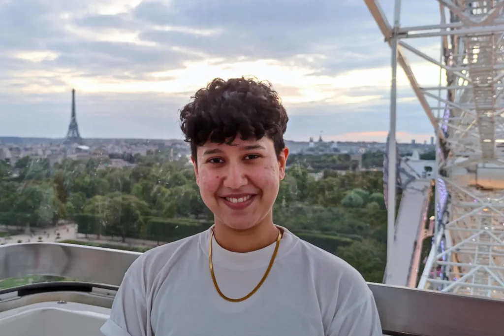 Marketing by Rocio founder smiling in Paris with the Eiffel Tower in the background, representing approachable and values-led marketing strategy