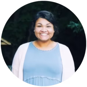 Sandra Yokley, founder of Backcourt Collective, smiling in front of dark background.