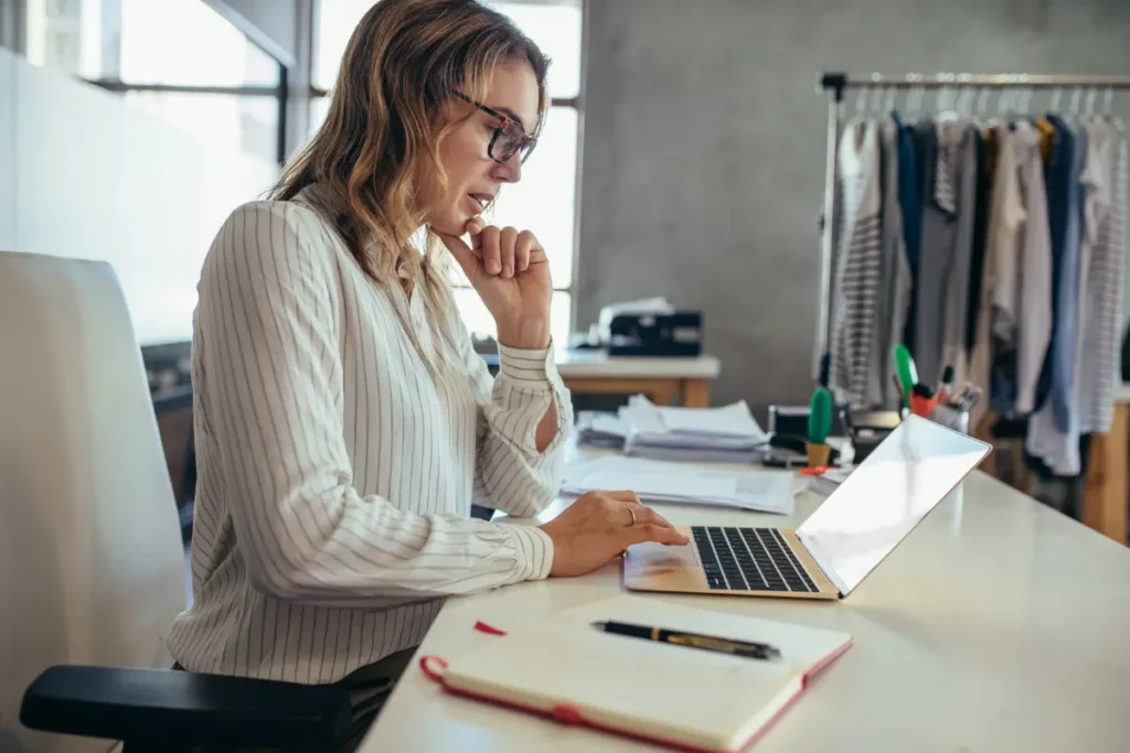 Small business owner working on a laptop for her visibility campaign